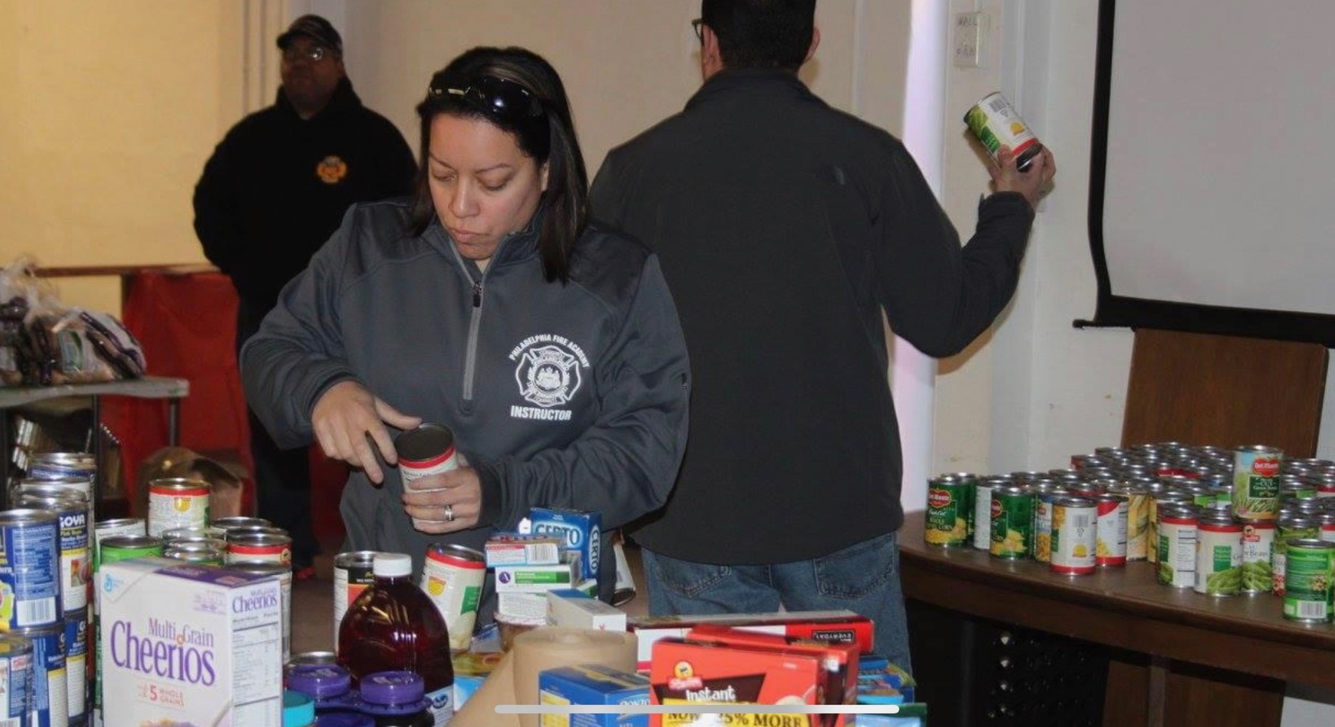 SAPFA member sorting canned goods at a community food drive