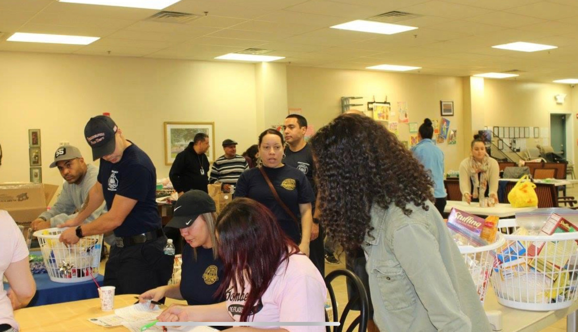 Volunteers and SAPFA members signing in and assembling Thanksgiving baskets